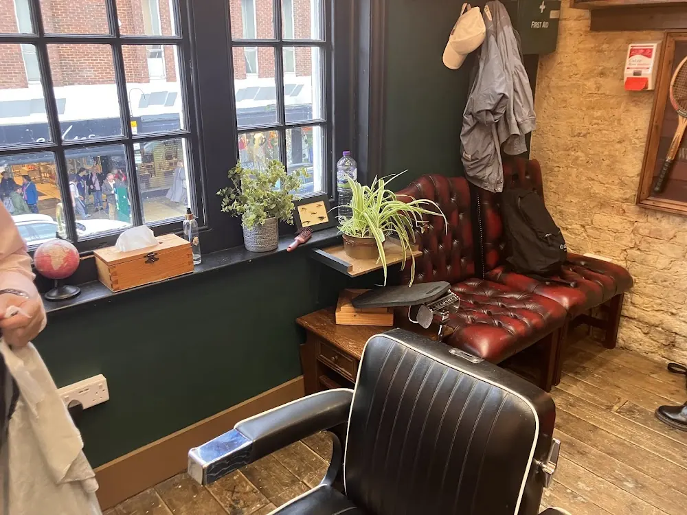 A barber chair and mirror inside the shop