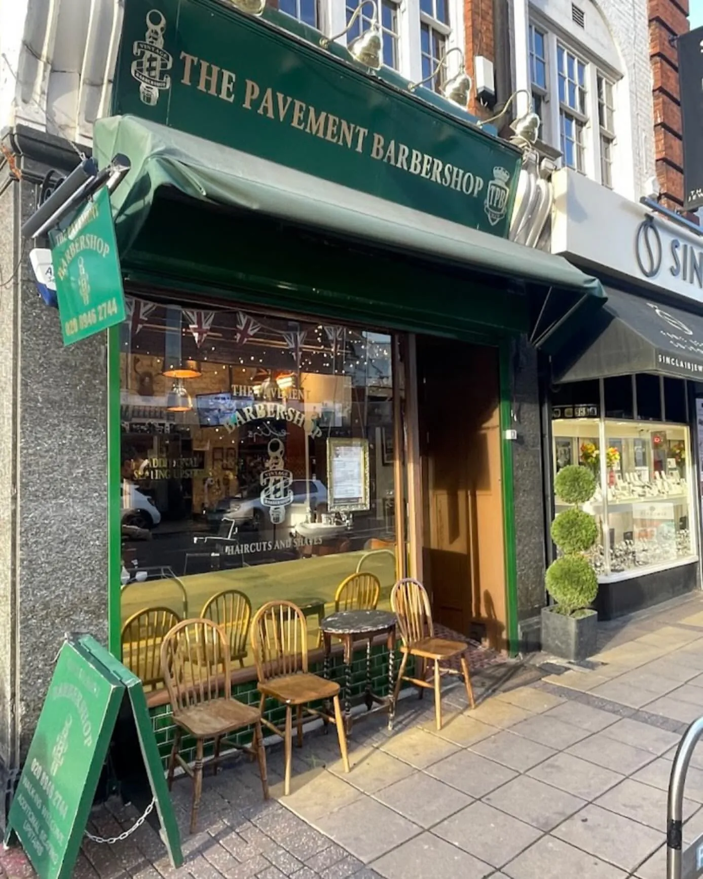 The Pavement Barbershop’s green shopfront on Worple Road