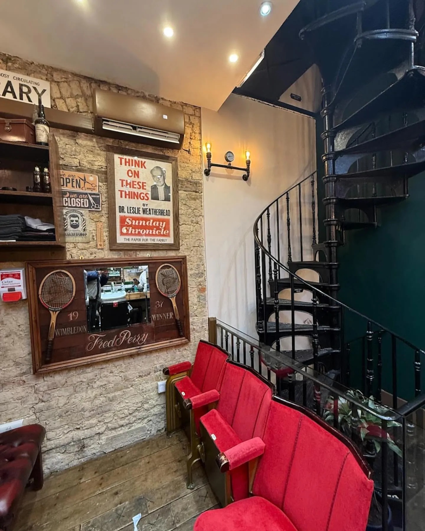 Red leather chairs by the spiral staircase inside the shop